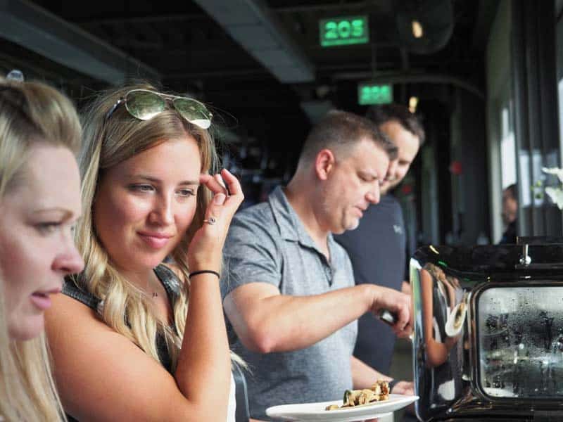 telnet worldwide staff in a buffet line at top golf