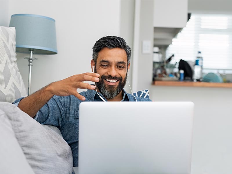 man working from home with team